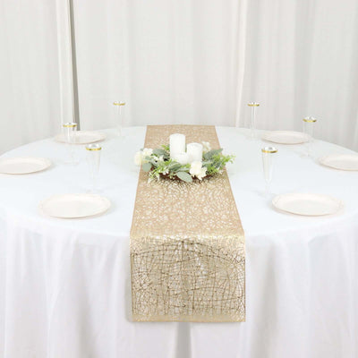 Gold table runner with floral centerpiece on a round table.