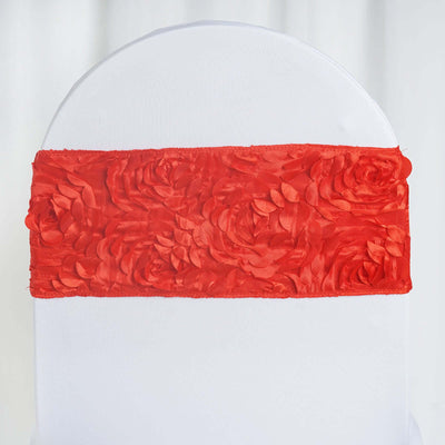 Red satin chair sash with floral design on a white chair.