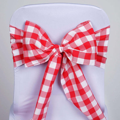 Red and white gingham chair bow on a white chair cover.