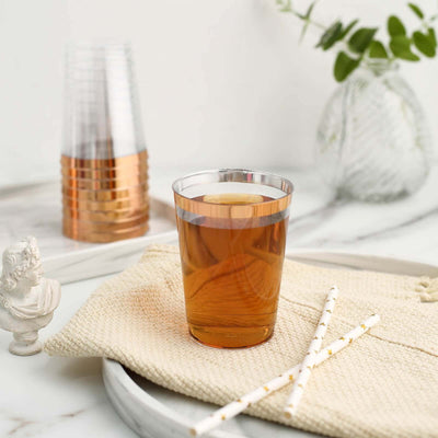 Copper-accented clear plastic cup with iced tea, styled on a neutral background.