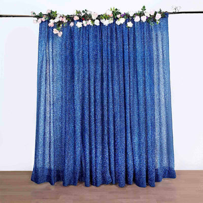 Blue glitter curtain with floral accents, perfect for event decor.