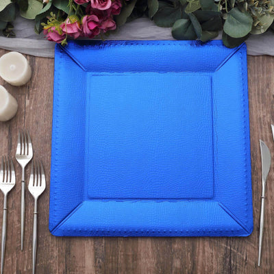 Blue textured serving tray on a wooden table with cutlery and candles.