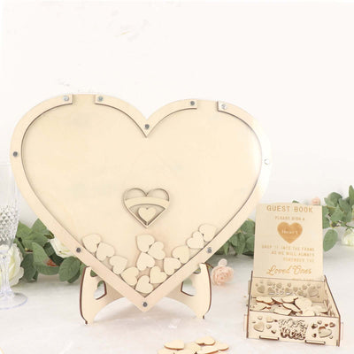 Wooden heart-shaped wedding guest book display with smaller heart inserts.