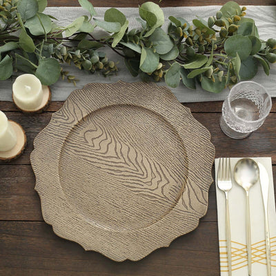 Textured decorative plate on a rustic table setting with greenery and candles.