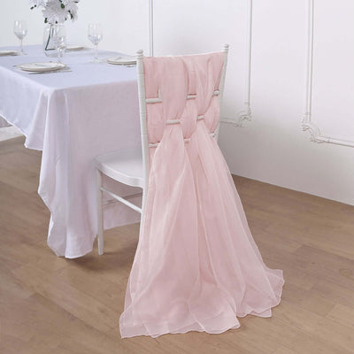 Pink chair sash draped elegantly over a white chair in a dining setting.