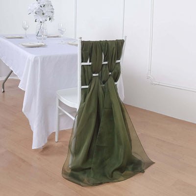 Olive green chair sash draped elegantly on a white chair at a dining table.