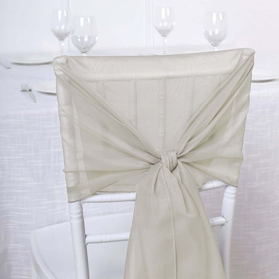 Elegant beige chair sash tied on a white chiavari chair.