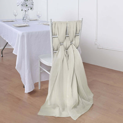 Elegant cream chair sash draped over a white chair at a dining table.