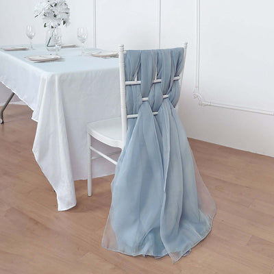 Light blue chair sash draped elegantly on a white chair in a dining setting.