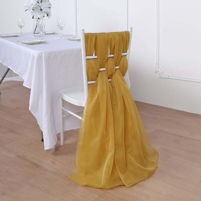 Yellow chiffon chair sash draped elegantly on a white chair in a dining setting.