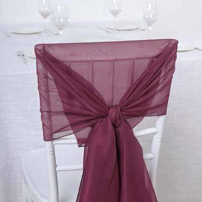 Burgundy chair sash tied in a bow on a white chiavari chair