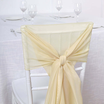 Elegant champagne-colored chair sash tied on a white chair.