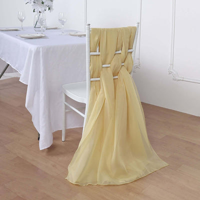 Yellow chair sash draped on a white chair at a dining table.