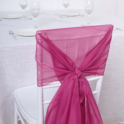 Pink sheer chair sash tied elegantly on a white chiavari chair.