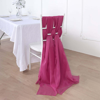 Pink chair sash draped elegantly on a white chair in a dining setting.