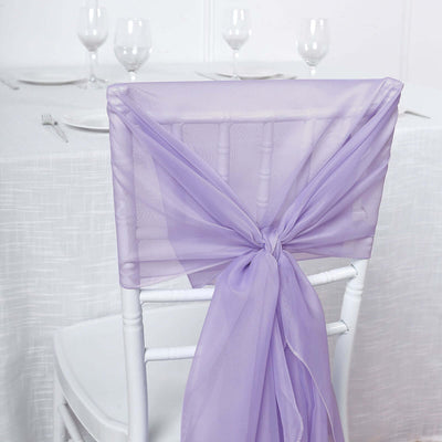 Purple chair sash tied elegantly around a white chair in a dining setting.