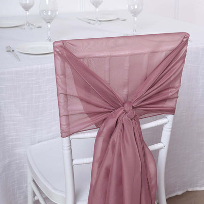 Lavender chair sash tied on a white chiavari chair at a dining table.