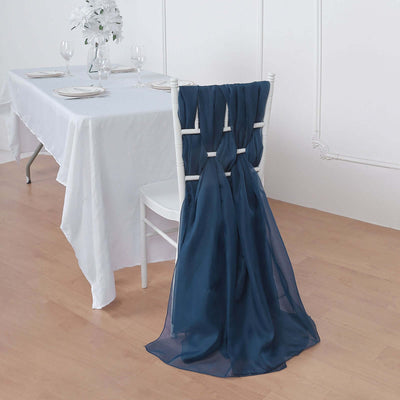 Navy chair cover draped elegantly on a white chair at a dining table.
