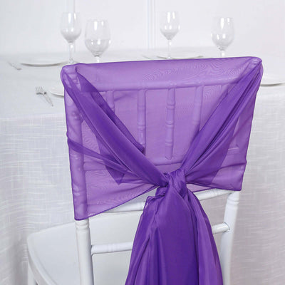 Purple chair sash tied elegantly on a white chair at a dining table.