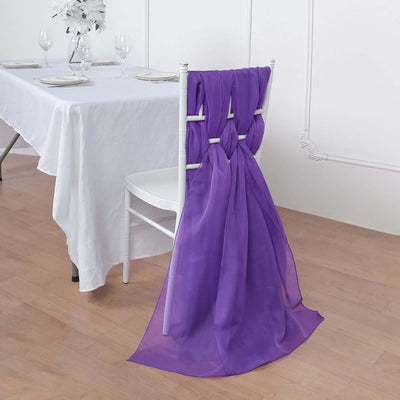 Purple chair sash draped elegantly on a white chair at a dining table.