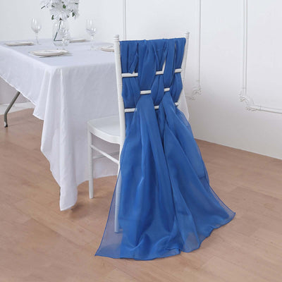 Blue chair sash draped elegantly over a white chair at a dining table.