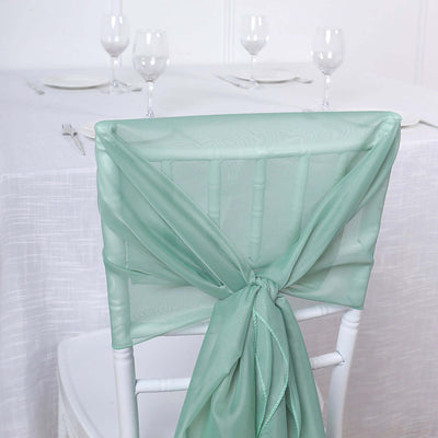 Mint green chair sash tied elegantly on a white chair.