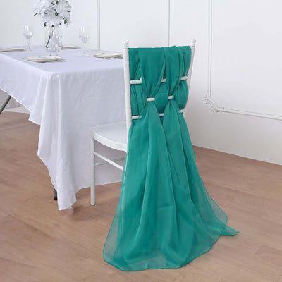 Turquoise chair sash draped elegantly over a white chair at a dining table.