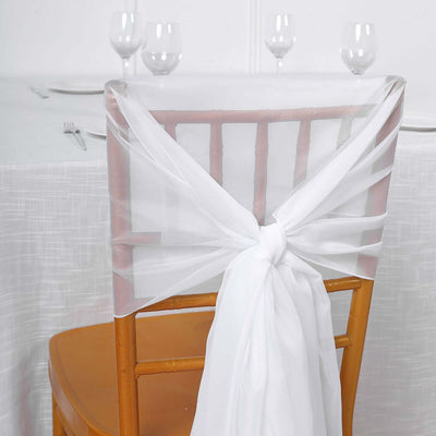 White organza chair sash tied elegantly on a wooden chair.