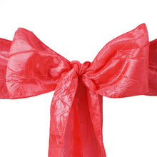 A close up of satin & taffeta chair sashes in red bow on a white background
