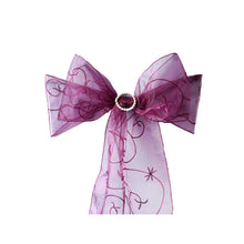 Organza & chiffon chair sashes - a purple bow with a rhinestone ring on it