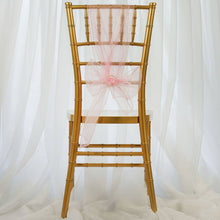 organza chair sash in pink color tied in a bow on a gold chair
