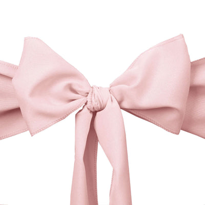 Pink satin bow tied in a decorative knot on a white background.