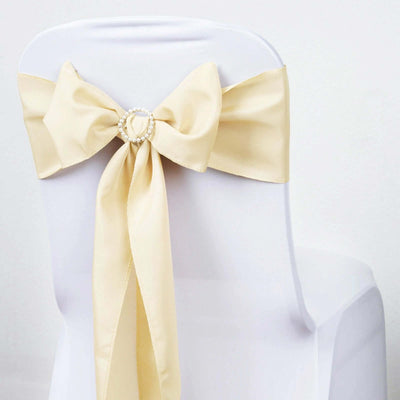 Elegant cream chair sash with a decorative pearl ring bow.