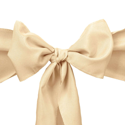 Beige silk bow tie on a plain white background