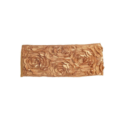 Rose-patterned gold decorative piece on a white background.