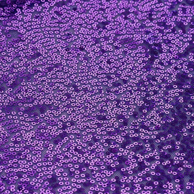Purple sequined fabric texture with shimmering details.