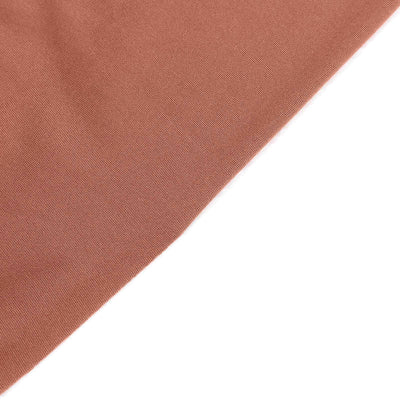 Close-up of textured fabric in warm terracotta color.