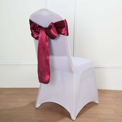 Burgundy satin chair sash tied on a white chair