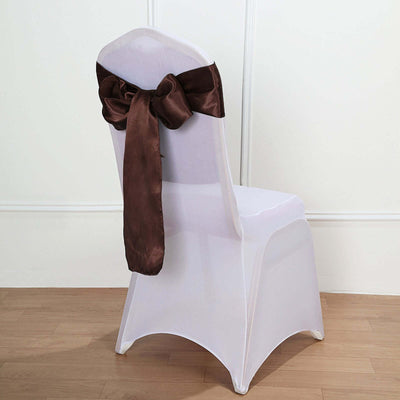 White chair cover with a brown satin bow on the back.