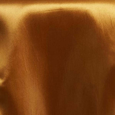 Shiny golden satin fabric texture close-up.