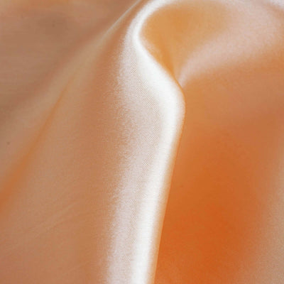 Peach satin fabric with a smooth, glossy texture.