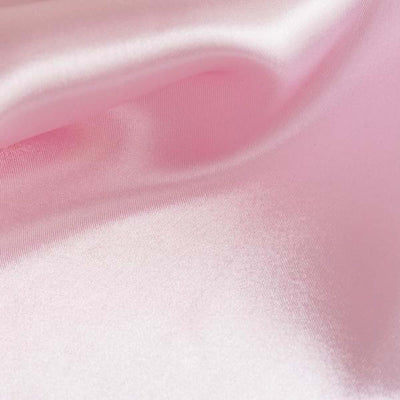 Soft pink satin fabric texture close-up.