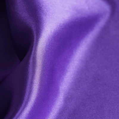 Close-up of luxurious purple satin fabric texture.