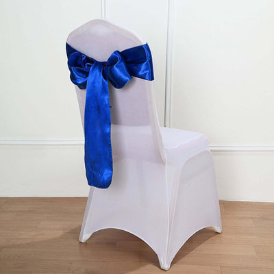 White chair with a blue satin bow tied on the back.