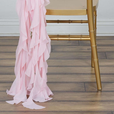 Pink ruffled fabric draped elegantly over a gold chair leg.