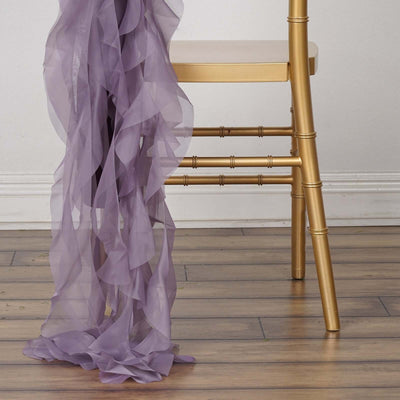 Purple chiffon drape cascading beside a gold chiavari chair.