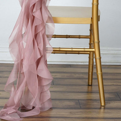 Gold bamboo chair with pink ruffled fabric draped over the side.