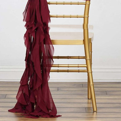 Burgundy chiffon drape elegantly cascading from a gold chair