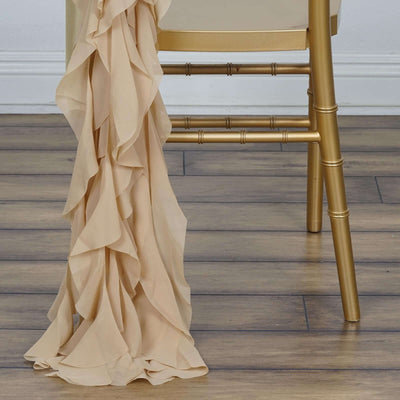 Nude ruffled fabric draped elegantly over a gold chair leg.