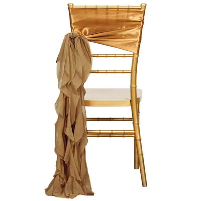 Gold chiavari chair with a gold satin sash and ruffled fabric draped elegantly.